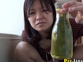 Japanese woman fills a container with her urine