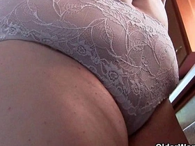 Voluptuous mature in nurse attire and hosiery pleasures herself