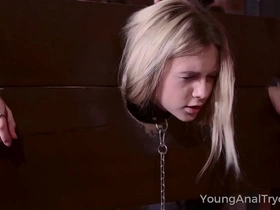Fresh-faced beauty explores BDSM with anal play in the dungeon