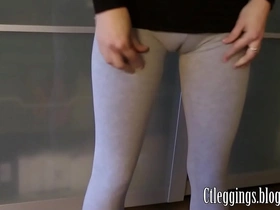 Yoga and stretching in tight grey leggings reveal tantalizing glimpses of ass