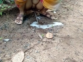 Watch a hot Indian babe pee in the woods