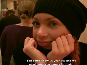 A fiery-haired vixen engages in an erotic encounter in a public restroom