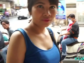 Aroused Thai woman with enhanced breasts engages in sexual encounter with a Caucasian man at a tuktuk driver's workshop