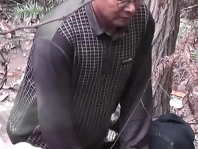 Aging Asian man has sex with a prostitute in a wooden building